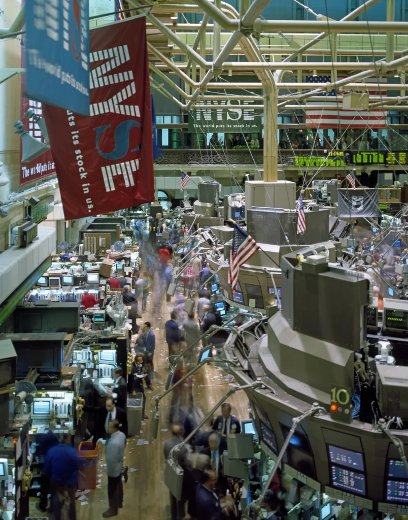 Traders and financial data screens in a busy stock market setting