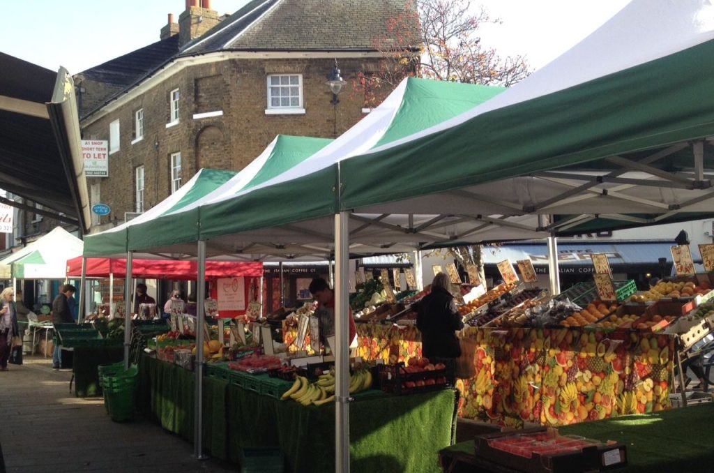 A farmers market stall with vegetables