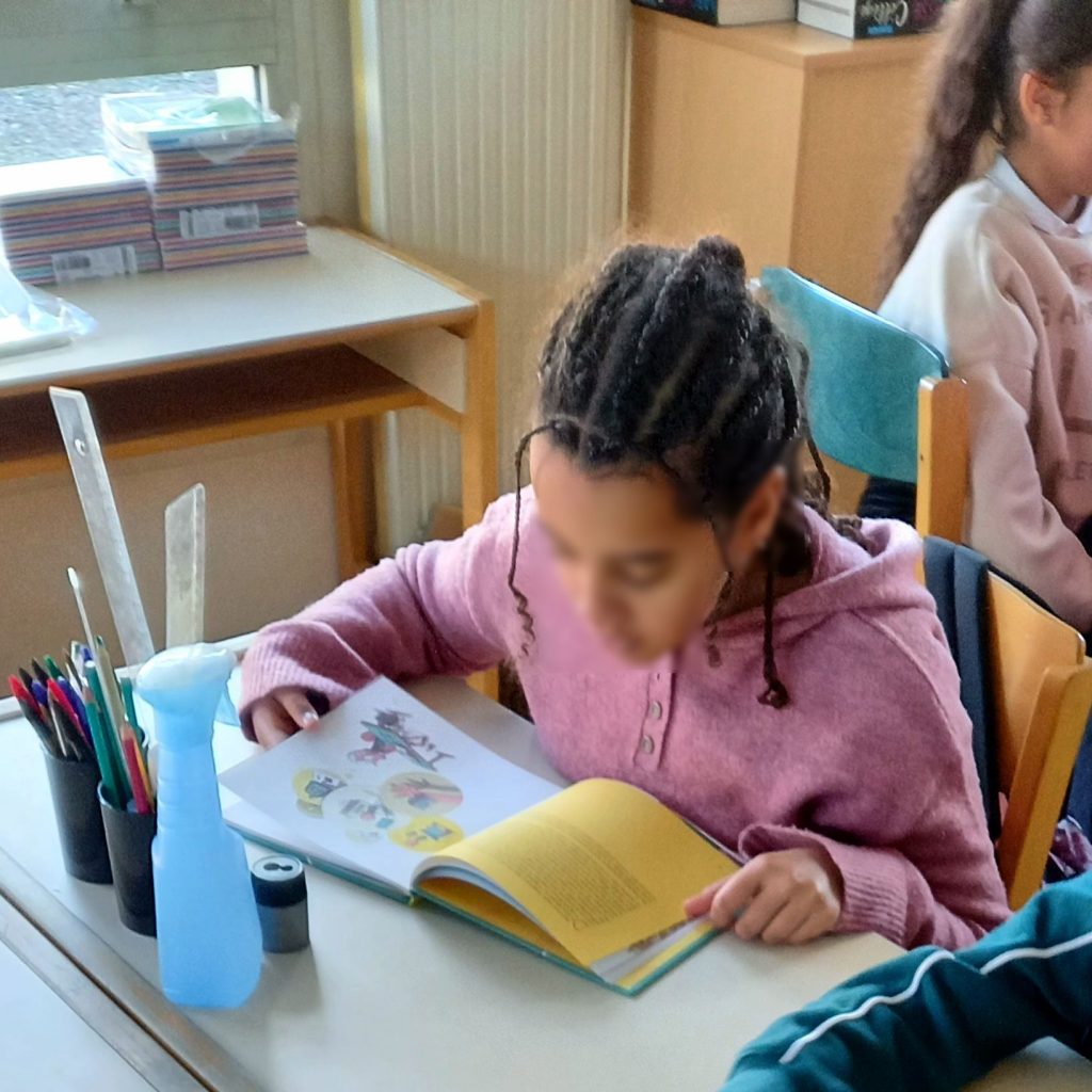Evidence Grows That Phone-Free Schools Raise Attainment Students in a phone-free classroom focusing on a lesson while smartphones stay put away
